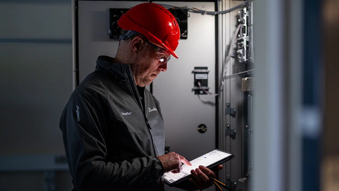 A Danfoss DrivePro rep running a site assessment. Maintenance, Repair and Operations (MRO) plans available from LED Controls.